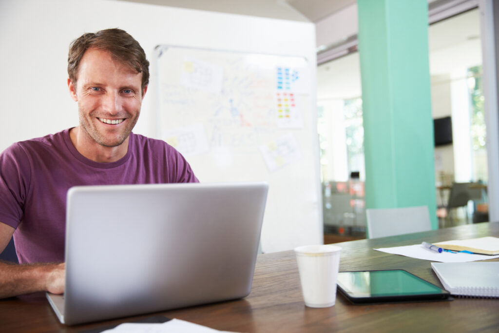 Portrait Of Businessman Working In Creative Office