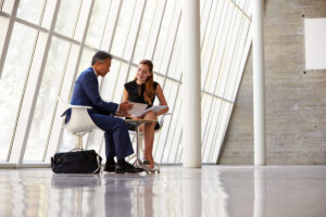 Two Businesswomen Meeting In Reception Of Modern Office #image_title